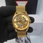 Guess Full Gold Skeleton Dial Swiss Watch with luxurious gold-tone stainless steel case, transparent skeleton dial, and premium automatic movement for men.