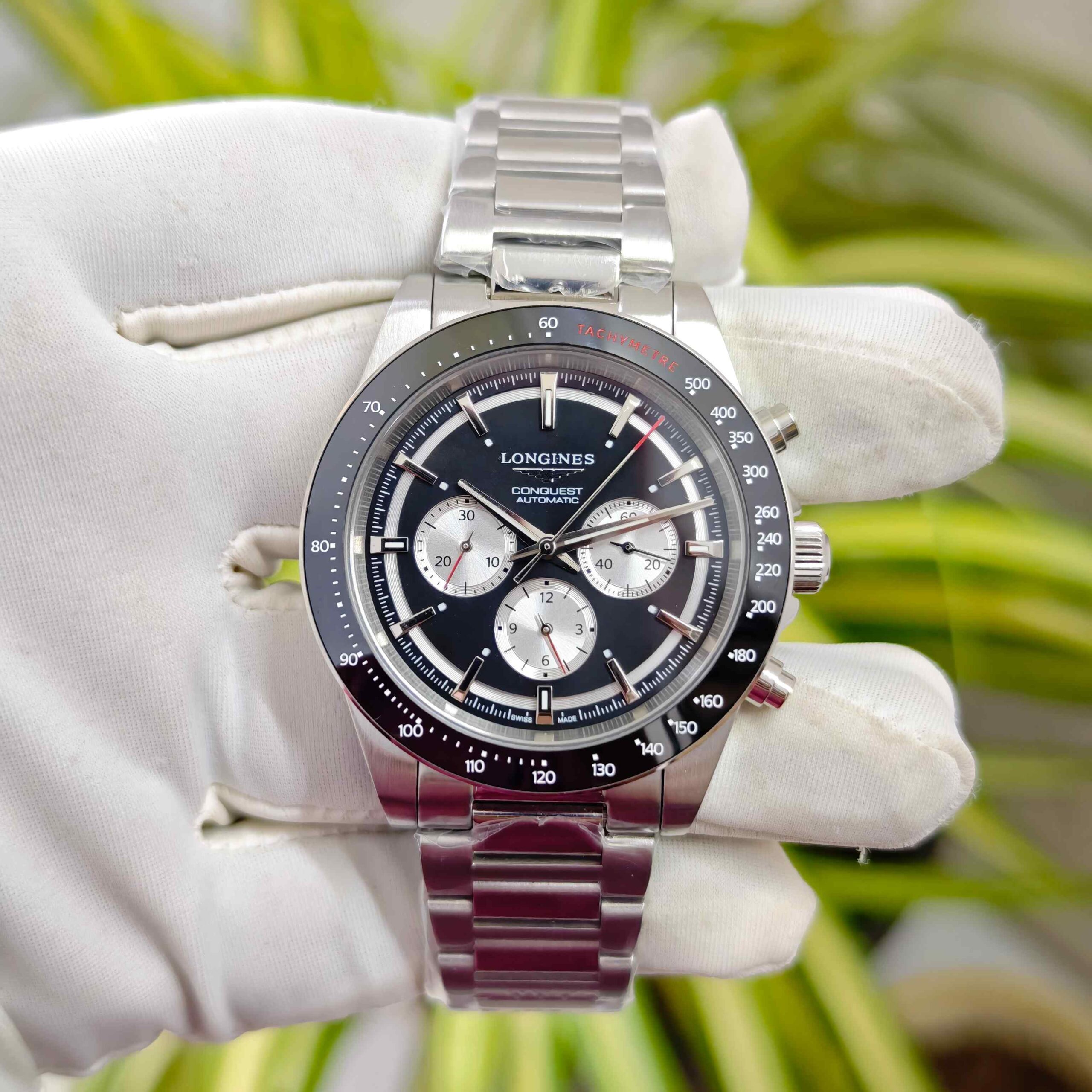 Longines Conquest White Chronograph stainless steel watch with black dial, chronograph subdials, and open case back luxury timepiece
