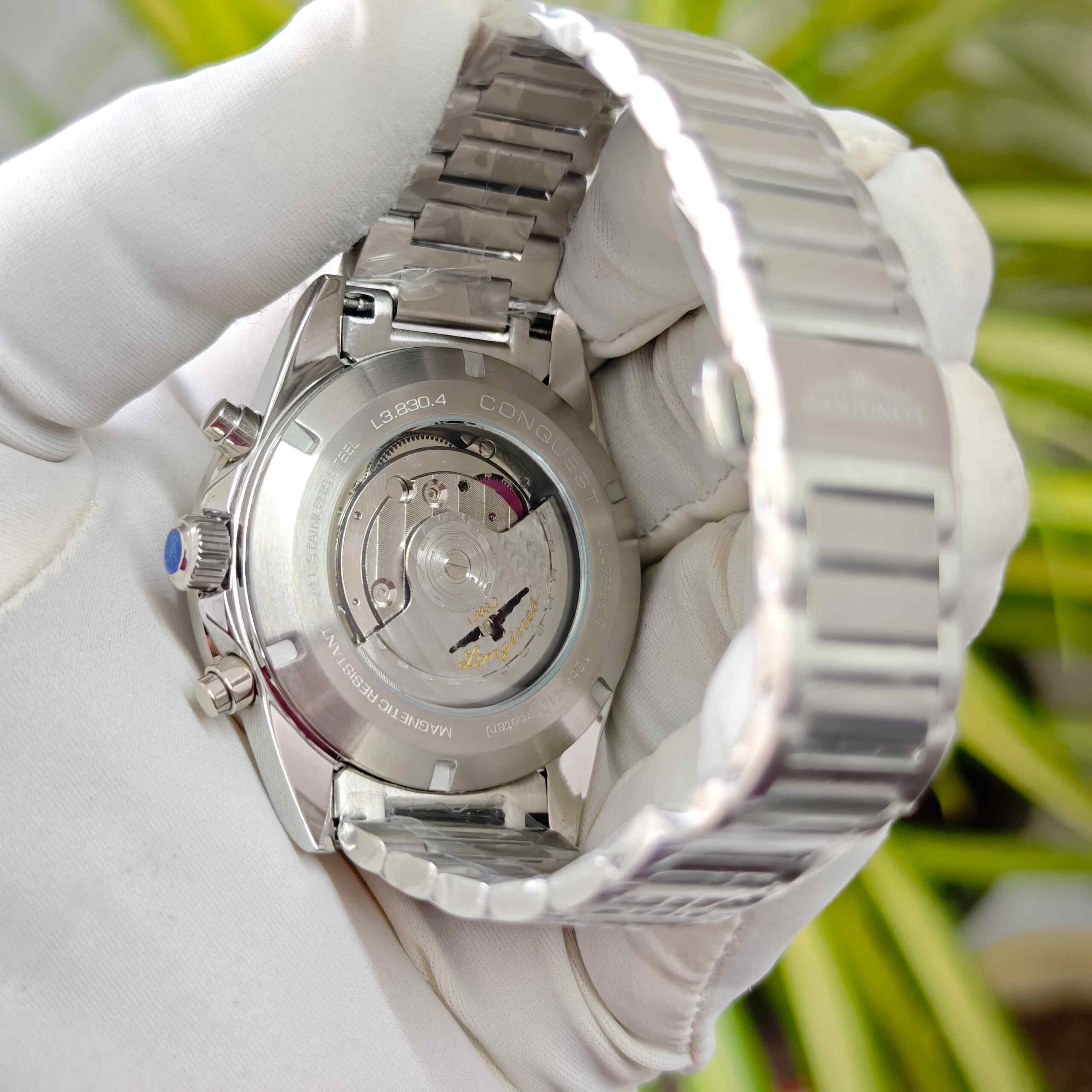 Longines Conquest White Chronograph stainless steel watch with black dial, chronograph subdials, and open case back luxury timepiece
