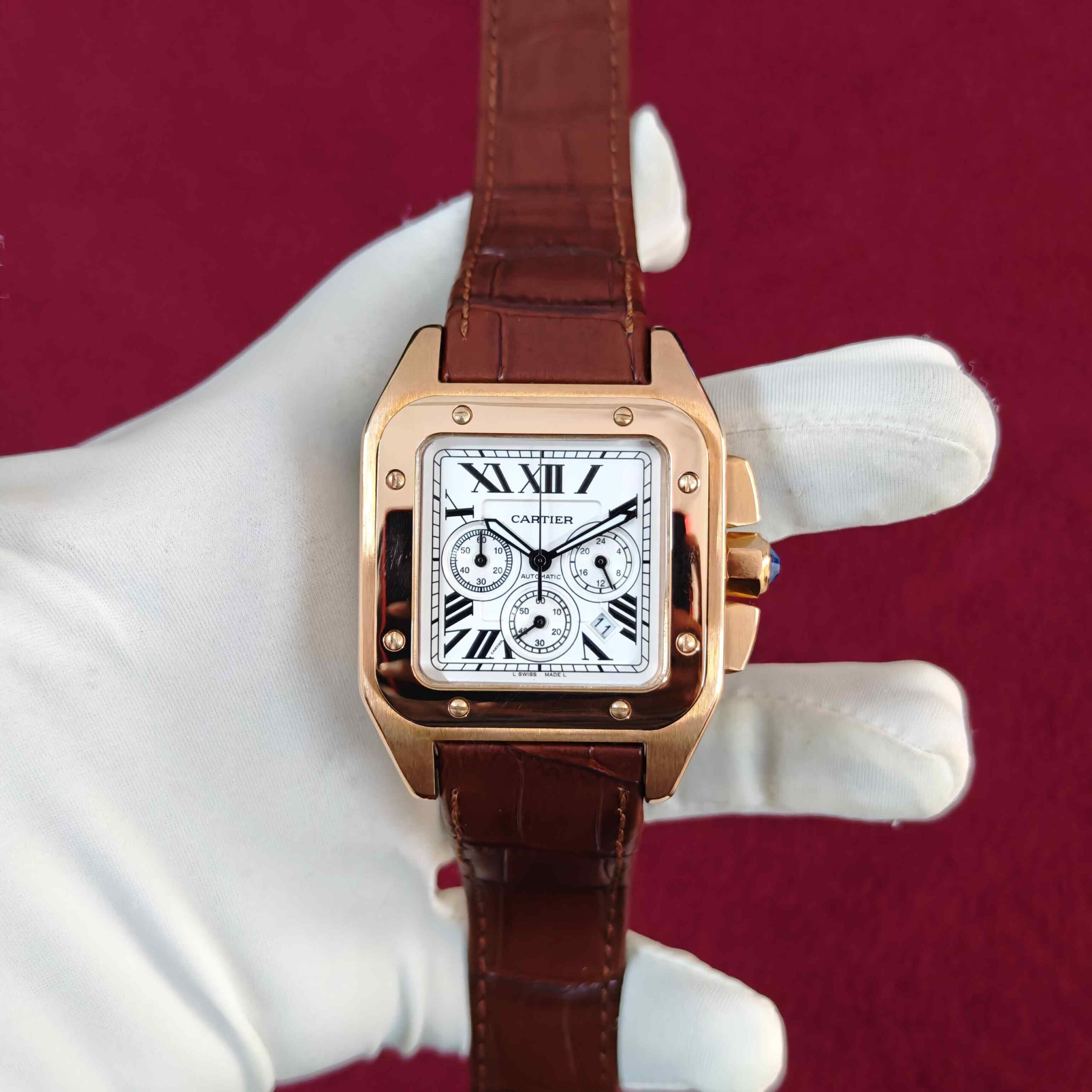 Cartier Santos Chronograph automatic watch featuring a rose gold case, elegant white dial, chronograph sub-dials, and premium brown leather strap.