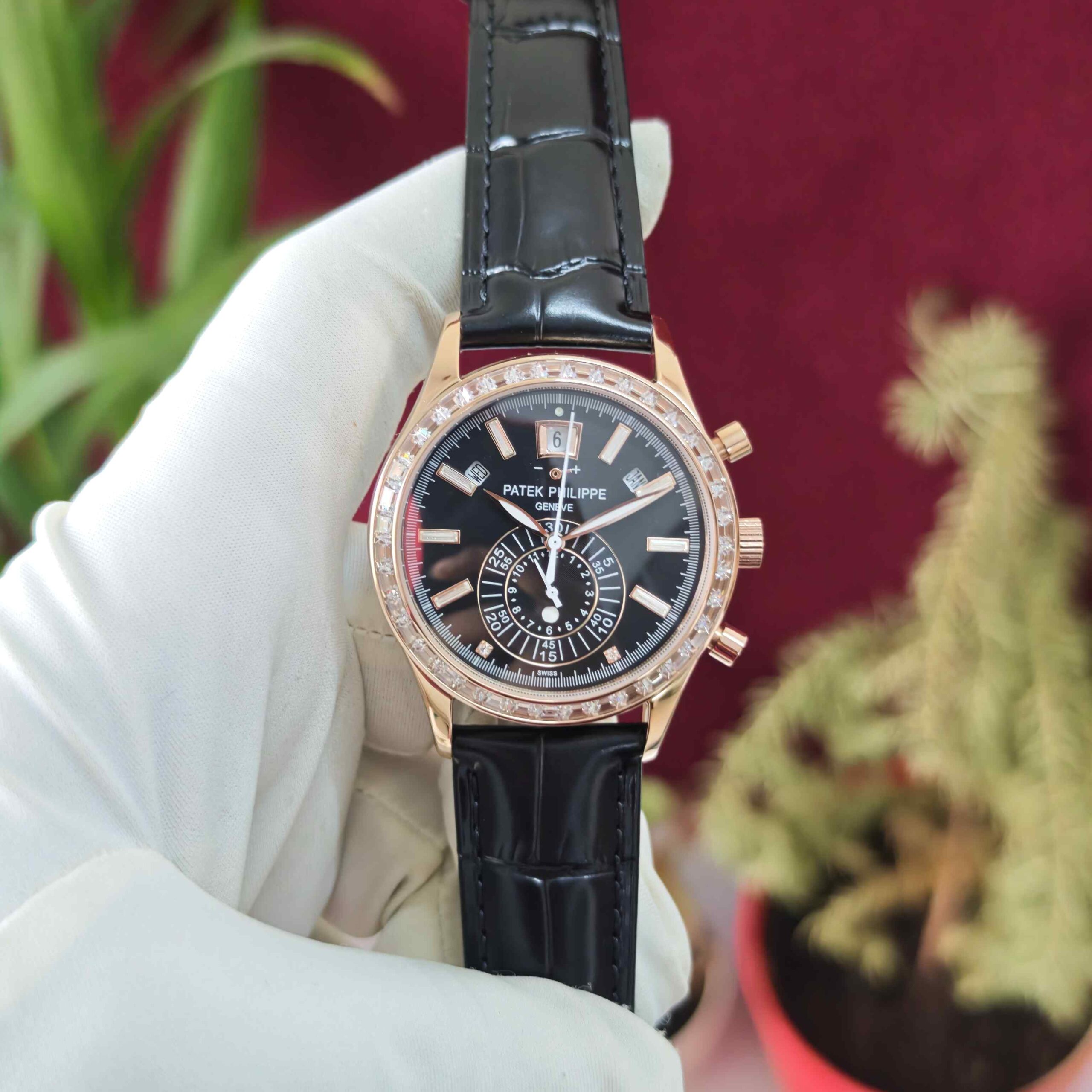 Patek Philippe Annual Calendar Chronograph rose gold automatic watch featuring a diamond bezel, detailed luxury dial, and premium leather strap.