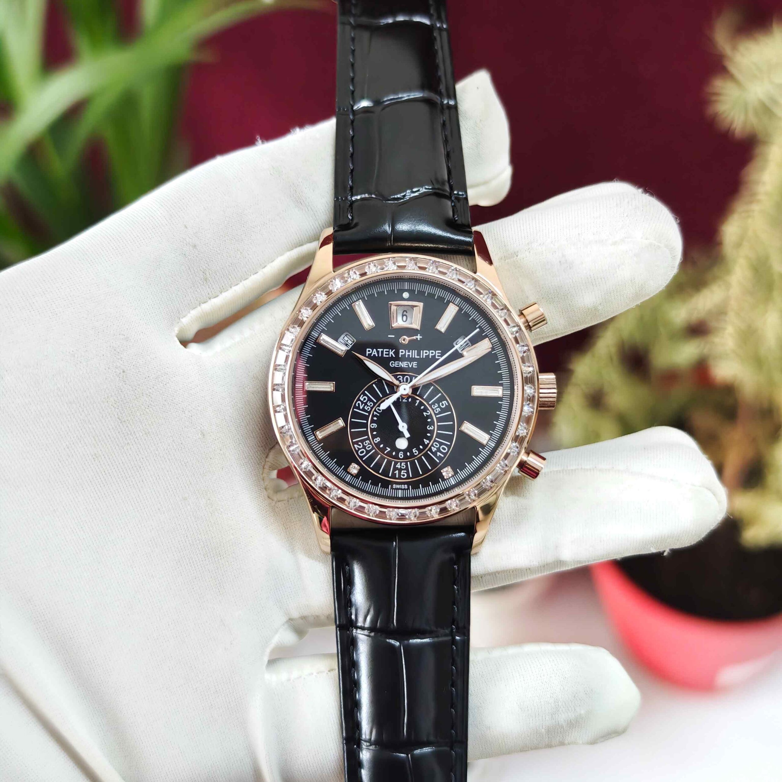 Patek Philippe Annual Calendar Chronograph rose gold automatic watch featuring a diamond bezel, detailed luxury dial, and premium leather strap.