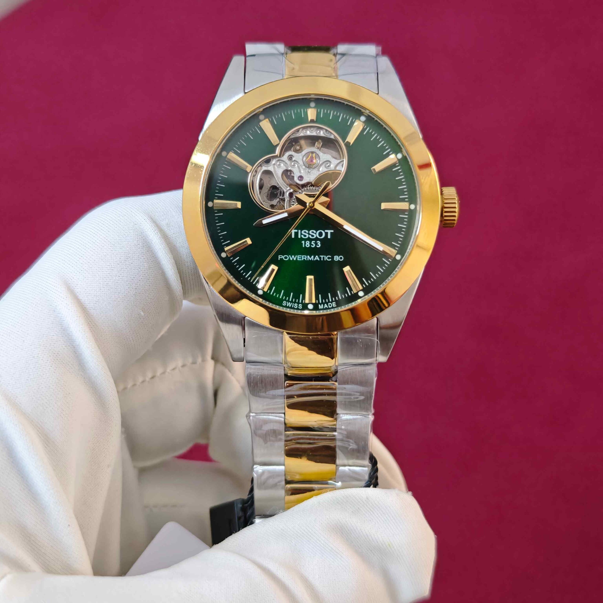 Tissot Gentleman Powermatic 80 Open Heart automatic watch featuring a green dial, gold dual-tone finish, elegant stainless steel bracelet, and sophisticated open-heart design.