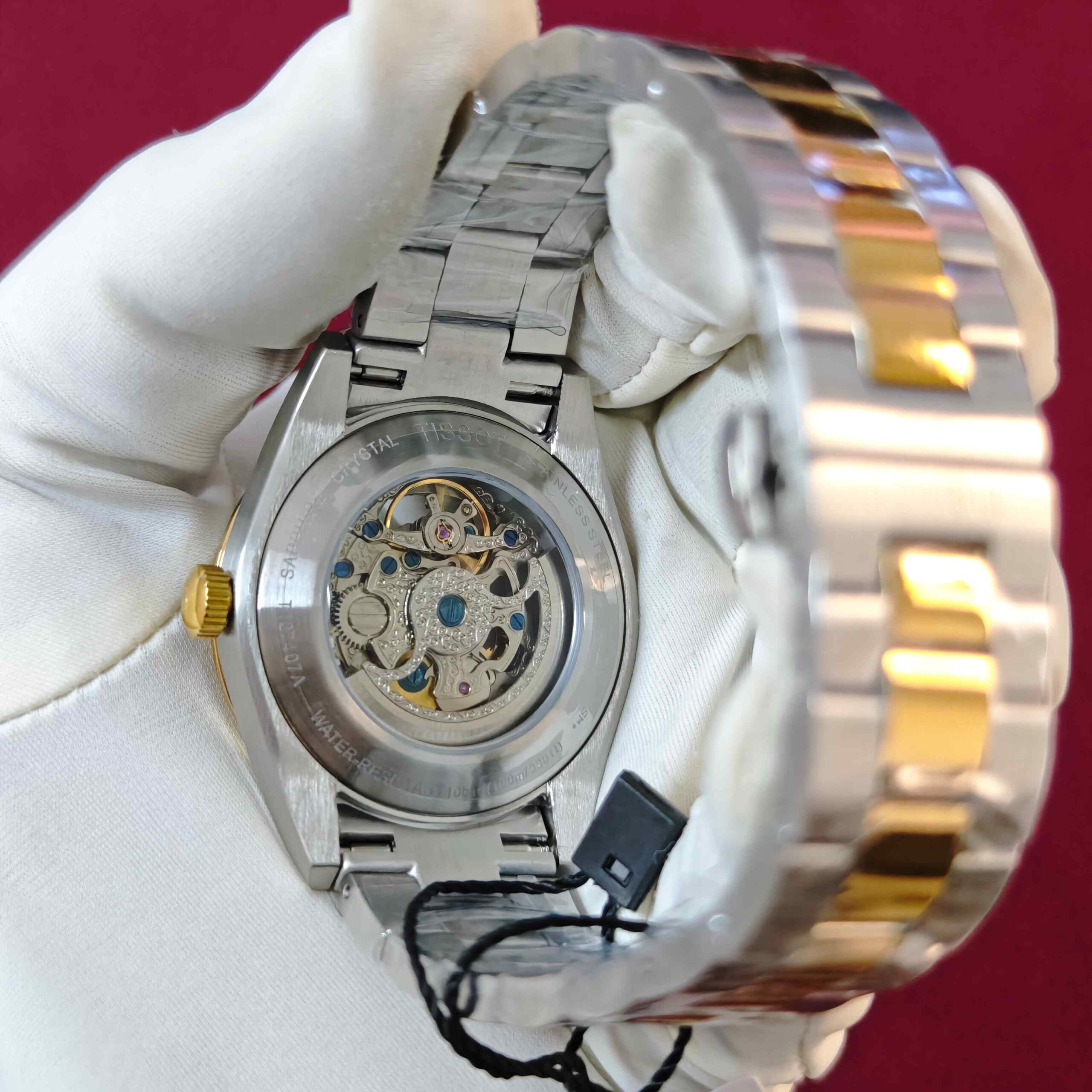 Tissot Gentleman Powermatic 80 Open Heart automatic watch featuring a green dial, gold dual-tone finish, elegant stainless steel bracelet, and sophisticated open-heart design.