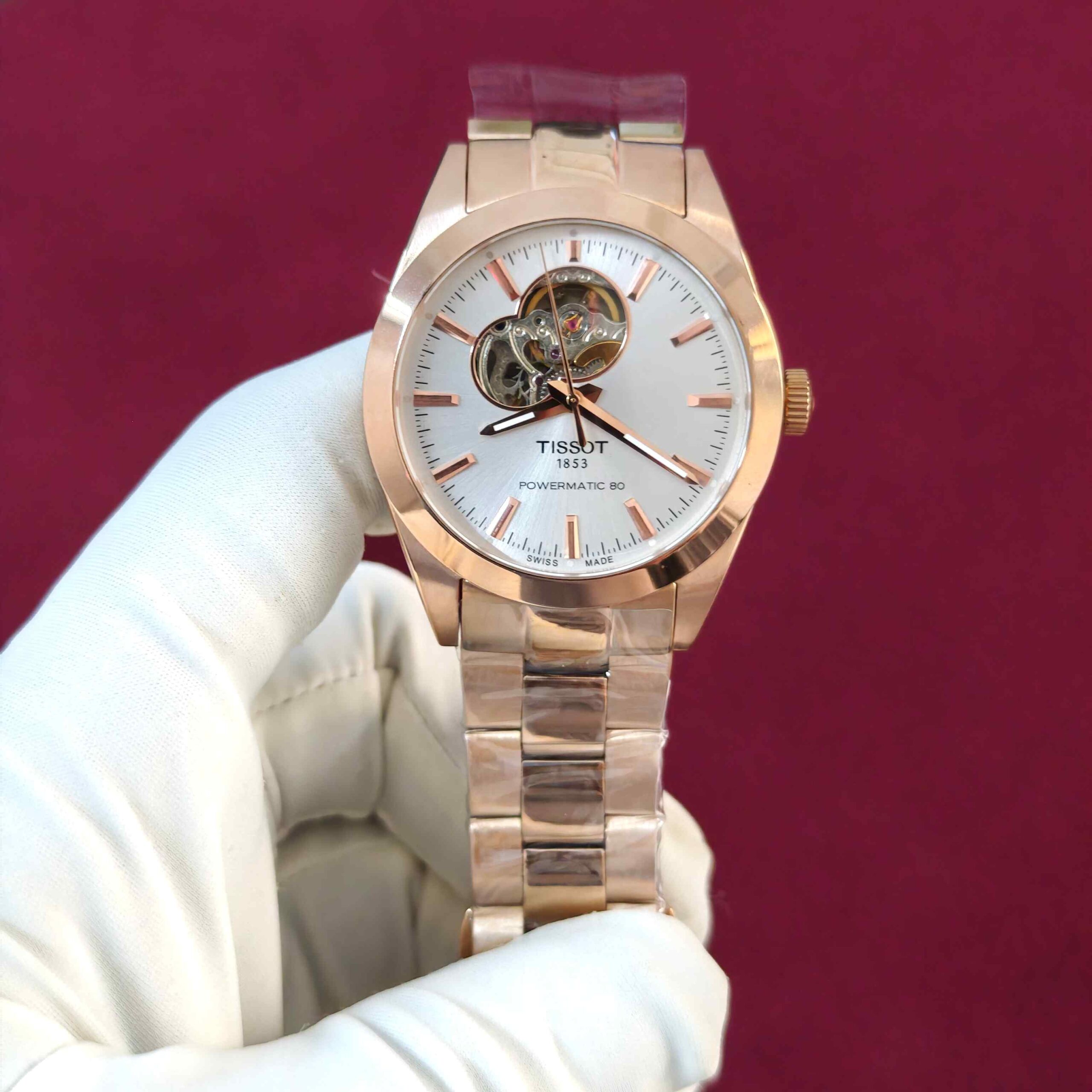 Tissot Gentleman Powermatic 80 Open Heart automatic watch featuring a rose gold-tone case, elegant white dial, and Swiss automatic movement.