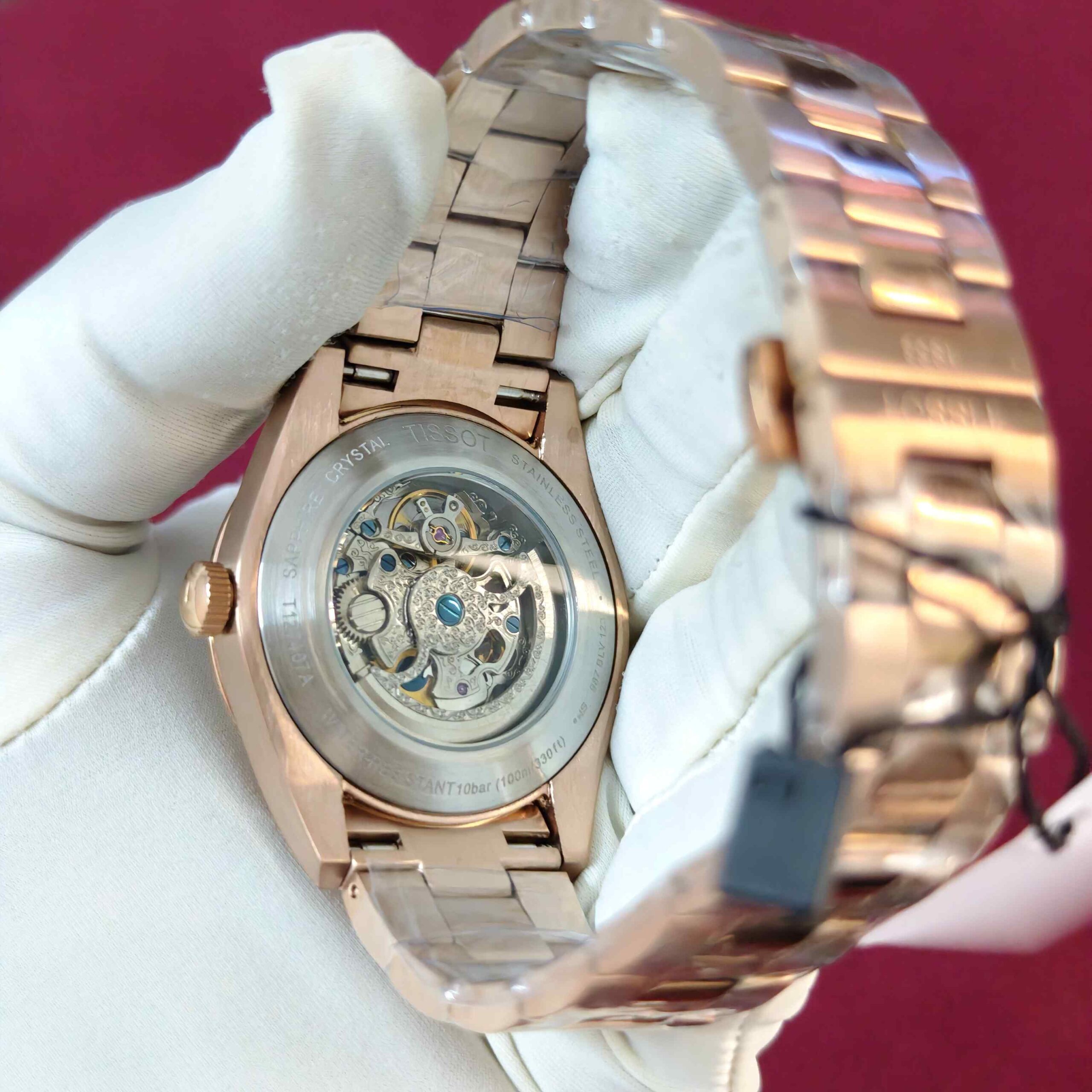 Tissot Gentleman Powermatic 80 Open Heart automatic watch featuring a rose gold-tone case, elegant white dial, and Swiss automatic movement.