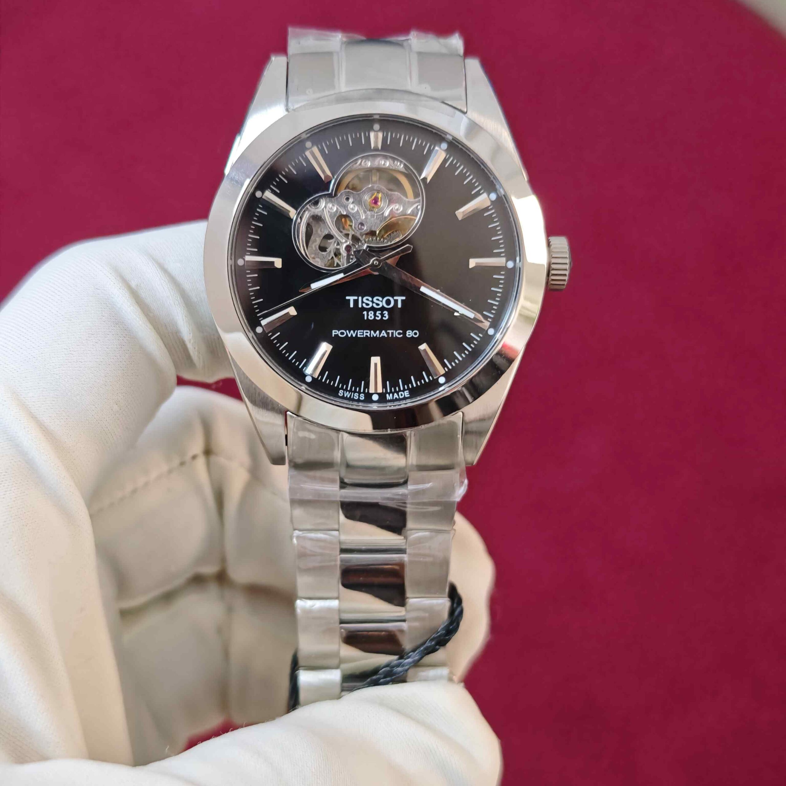 Tissot Gentleman Powermatic 80 Open Heart automatic watch with black dial, stainless steel case and bracelet, featuring an elegant open-heart dial design.