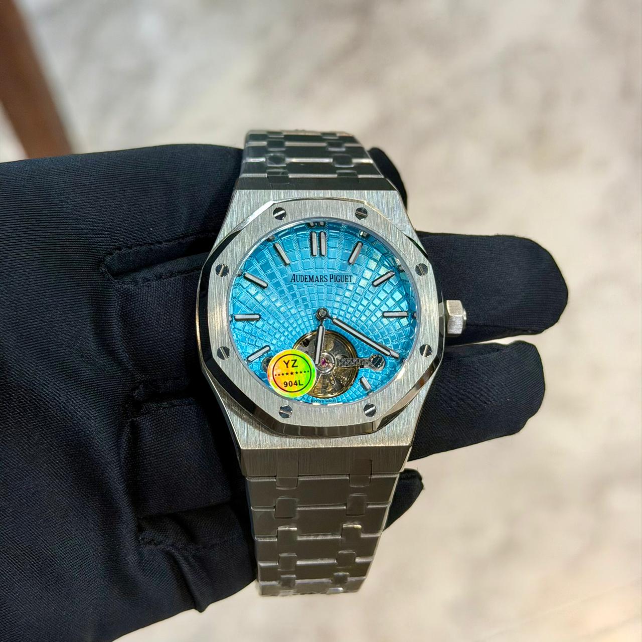 Audemars Piguet Royal Oak Flying Tourbillon with vibrant blue dial, stainless steel case, luxury automatic movement, and sapphire crystal.