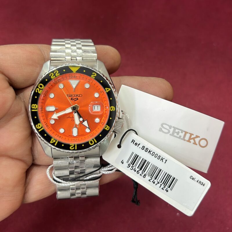 Seiko 5 Sports GMT SSK003K1 Orange Dial Swiss Automatic Watch with stainless steel bracelet and sporty GMT bezel.